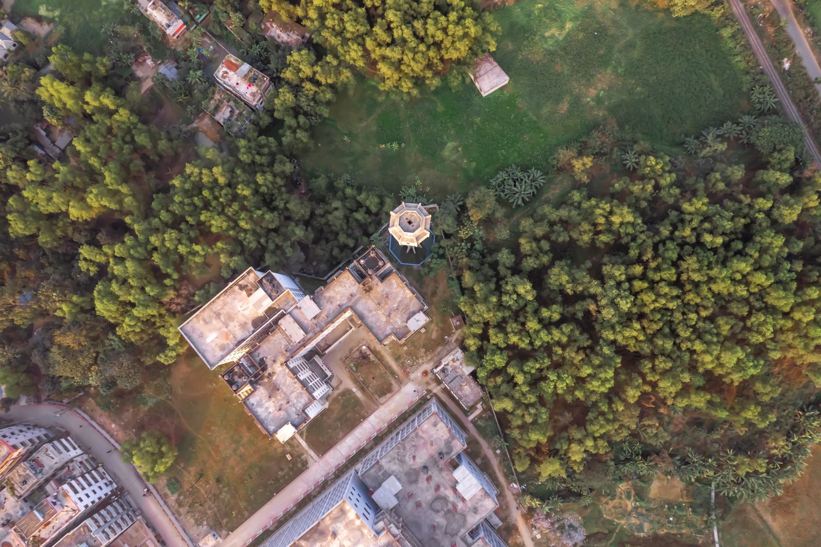 Aerial view of buildings, a water tower and surrounding forest